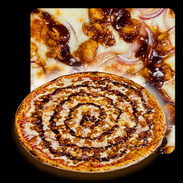 Golden Lizzard Pizza's BBQ chicken pizza with red onions and a swirl of sauce.