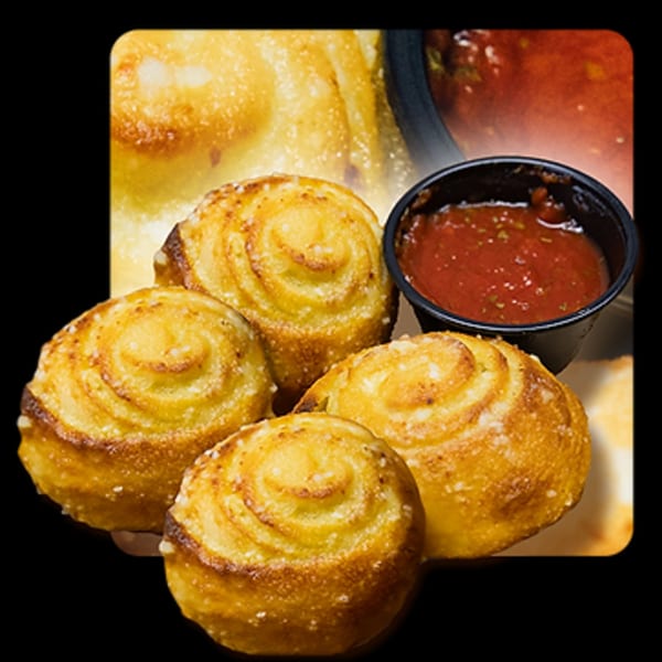 Golden Lizzard Pizza's garlic knots, golden brown and sprinkled with cheese, served with marinara sauce.