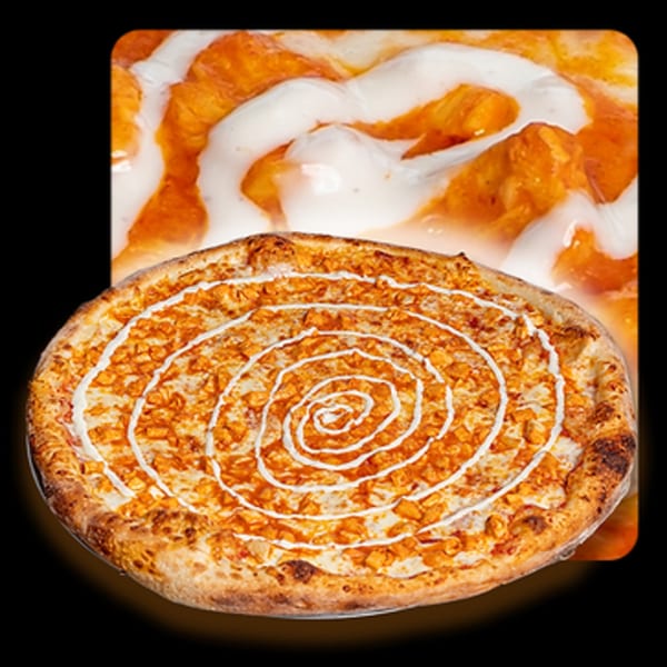 Golden Lizzard Pizza's buffalo chicken pizza with a spiral of white sauce on a dark background.